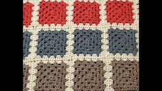 a crocheted blanket is shown with different colors and shapes on the bottom half