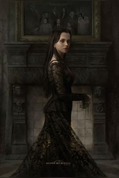 a woman in a black dress standing next to a fireplace