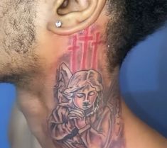 a man with a tattoo on his neck and behind him is an ear piercing that has the image of a woman holding a cross