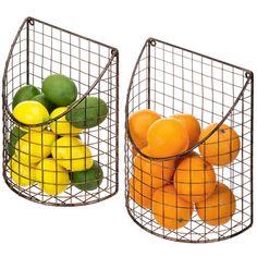 two metal baskets filled with fruit sitting next to each other