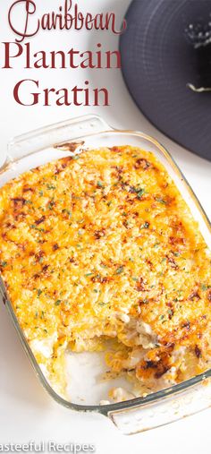 a casserole dish with cheese and vegetables in it on a white table next to a blue hat