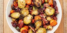 roasted brussel sprouts in a white bowl on top of a wooden table