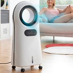 a woman laying on a couch next to an air purificater with the words innovagods above it