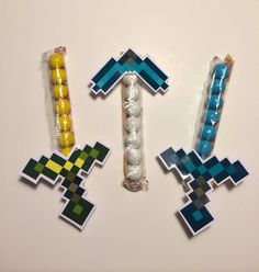 three pieces of art made to look like minecraft characters, each with different colors and shapes