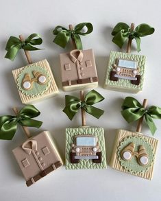 decorated cookies with green bows and bow ties on them are arranged in the shape of boxes