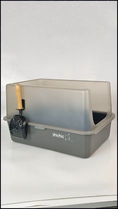 a gray container with a wooden handle on it