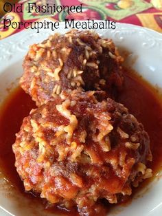 two meatballs covered in marinara sauce on a white plate with the words old fashioned porcupine meatballs