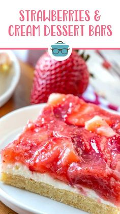 strawberry cheesecake and cream dessert bar on a plate with strawberries in the background