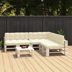 a white couch sitting on top of a wooden deck