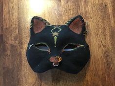 This is a simple, high quality Therian mask. It has never been used and was made in 2024. None of the accessories are meant to come out. It is handmade by me with quality materials. It is one of a kind. Warning: This mask is not waterproof. The mask base will be destroyed if it goes in the water and the paint might bleed. Swimming with it or using it in the rain will destroy the mask. Handmade Black Masks And Prosthetics For Costume, Handmade Black Masks For Costume Party, Handmade Adjustable Masks For Masquerade, Handmade Artistic Eye Mask, Handmade Black Masks For Carnival, Handmade Black Masks And Prosthetics, Handmade Adjustable Mask For Masquerade, Artistic Handmade Black Masks, Therian Mask