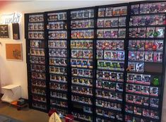 a room filled with lots of different types of video games on the wall next to each other