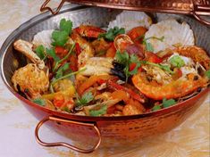 a large pot filled with lots of food on top of a table