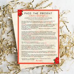 a paper with the words pass the present on it next to some confetti