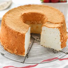 a cake on a cooling rack with one slice cut out and the other half eaten