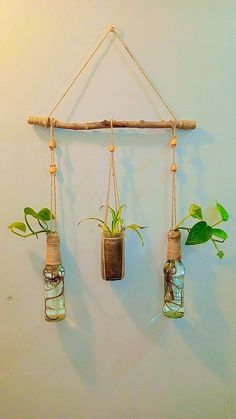 three hanging planters with plants in them