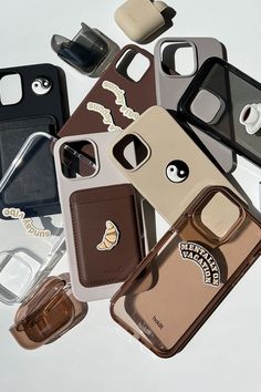 an assortment of cell phone cases sitting on top of each other with different designs and shapes