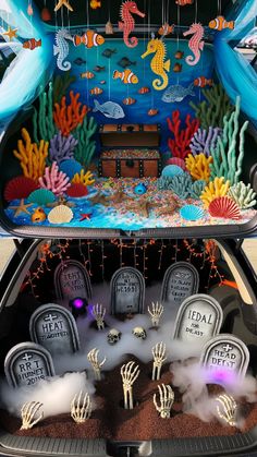 the trunk of a car decorated with fake skeletons and seahorses for halloween decorations