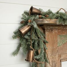 a christmas wreath with bells hanging from it