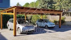 two cars are parked in the driveway under a pergolated area with wooden posts