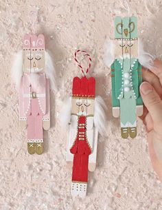 three handmade christmas decorations are displayed on a table