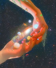 two hands reaching out towards each other in the sky with planets and stars around them