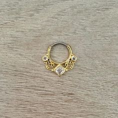 a gold ring with two diamonds on it