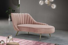 a pink couch sitting on top of a rug