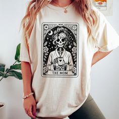 The Mom Tarot Card Shirt, Skeleton Mother T-Shirt. Product Description * Material: This T-Shirt Is Crafted From 100% Open-End Cotton, Ensuring Comfort And Durability. * Sizes: Available In A Range From S To 3xl, Finding Your Perfect Fit Is Easy. Check Out Our Comprehensive Sizing Chart In The Product Photos To Ensure The Ideal Size For You. Double-Check Your Selection Before Completing Your Purchase To Avoid Any Sizing Issues. * Processing: Your Order Will Be Securely Processed And Shipped Withi White Graphic Tee With Skull Print, White Skull Print Graphic Tee, Mom Fits, Tarot Card Shirt, Vintage Tarot Cards, Tarot Gifts, Vintage Tarot, Skeleton Shirt, Mama Tee