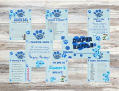 the paper raftie baby shower game is shown on a wooden table with blue paw prints