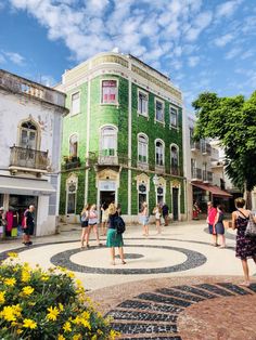 people are standing in front of a green building