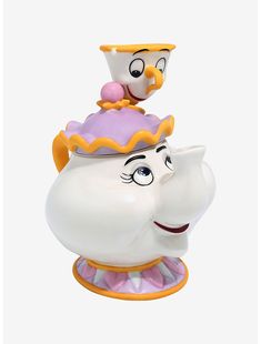 the beauty and the beast teapot figurine is sitting on top of it's head