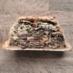 a piece of bread with mushrooms and cheese on it