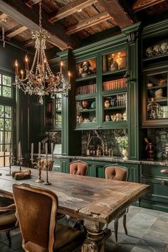 an old fashioned dining room with green cabinets and chandelier hanging from the ceiling