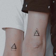 two people with matching tattoos on their arms