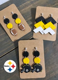 three pairs of earrings with pittsburgh football logo and black, white, and yellow accents