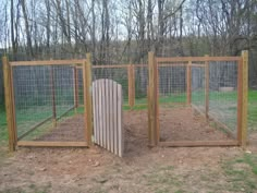 an outdoor chicken coop with two doors and one door open on the ground in front of some trees