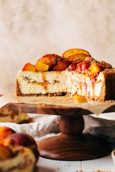 a piece of cake sitting on top of a wooden platter next to some fruit