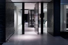 Sleek LA modern loft home with textured black walls & pivot door entry. Pivot Doors Entry, Black White Palette