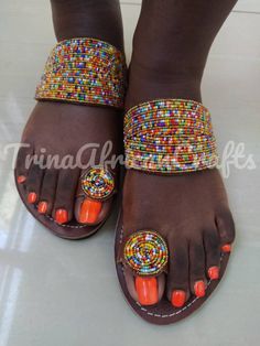 This sandals are a beautiful work of art carefully handcrafted in Kenya to suit your versatile needs. The pure leather is soft to ensure comfortability to the wearer. The sandal is strong and durable made with the African rough roads in mind; additionally they have a fine touch of bead work to complete it's beautiful look. Available in all sizes. 😊 Traditional Open Toe Flip Flops For Festivals, Traditional Sandals With Adjustable Single Toe Strap, Traditional Open Toe Barefoot Sandals For Festivals, Traditional Multicolor Toe Post Sandals, Artisan Multicolor Open Toe Sandals, Traditional Beaded Barefoot Sandals With Single Toe Strap, Fair Trade Open Toe Sandals For Festival, Fair Trade Round Toe Sandals, Traditional Beaded Sandals With Round Toe