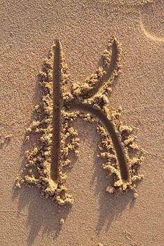 the letter k is drawn in the sand