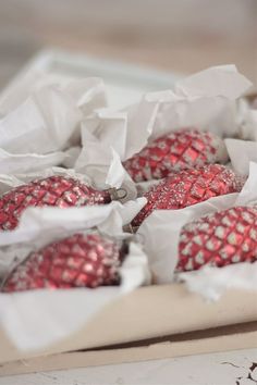 some red and white ornaments are in a box