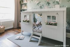 a child's bedroom with flowers on the wall