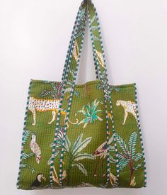 "Cotton quilted Jhola Bag made by Indian Artisans, this cotton quilted shopping bag is totally unique and multi purpose. Use this for your grocery or as a travel bag. Perfect to suit all. The Indian Hand Block Printed Cotton Quilted Women's Handbags from Rajasthan India. This Handbag is completely Indian Printed on good quality cotton. Material:  Cotton Fabric Color - Green Pattern: Floral  Style: Tote Bag, Handle Bag, Shoulder Bag Size in Inch:- Height-18\" inch Width- 19\" inch Handle-13\" inch Product Work: Printed & quilted Stitched Usage : Cosmetic, Make-up, Travel, Toiletries, Medicine, Accessories, Shopping and much more. Perfect for Beach Visits/ Quick Grocery runs/ Carrying Kids items/ Artist Paint book and Paints /Extra Bag Washable on Cold / Delicate wash Make a good Sustainable Square Green Quilted Bag, Green Quilted Square Bag, Green Quilted Rectangular Bag, Green Quilted Shopping Bag, Everyday Green Quilted Bag, Green Quilted Bag For Daily Use, Green Reversible Cotton Shoulder Bag, Green Quilted Tote Shoulder Bag, Quilted Cotton Shoulder Bag For Travel