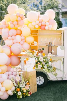 an ice cream truck decorated with balloons and flowers