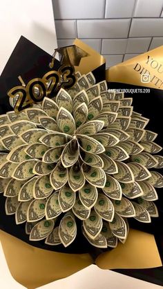 a bunch of money sitting on top of a black and gold gift bag with the year 2009 written on it