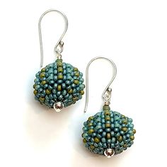 Beaded Earrings - Small glass beads in luxe Orchid hues or warm Aegean blue-green are hand woven one at a time around lightweight acrylic orbs. Sterling silver accent beads add extra polish. Comfortable sterling silver ear wires complete the look. Artisan Blue Beaded Round Earrings, Turquoise Large Beads Drop Earrings, Blue Round Beaded Earrings With Spacer Beads, Artisan Blue Beaded Earrings, Turquoise Drop Earrings With Large Beads, Green Artisan Round Bead Earrings, Adjustable Green Beaded Earrings With Large Beads, Orb Earrings, Aegean Blue