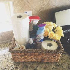 a basket filled with toilet paper next to a stove