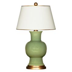 a green lamp with a white shade on it