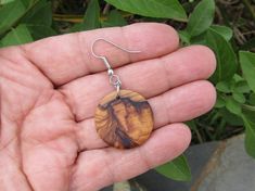 Beautiful very light round Earrings in olive wood Diameter 2,5 cm (0.98 INCH ) Total Lengths of the earrings ~ 5 cm ( 2 INCH ) The ear hooks are made of stainless steel and therefore suitable for people with allergies naturally the grain of the olive wood can vary from item to item , but in any case you will get a pair of olive wood hoops with beautiful grain. You can find more olive wood earrings ,rings , bracelets and necklaces in our shop ! Handmade in Portugal Handmade Round Natural Wood Jewelry, Natural Wood Drop Earrings, Nature-inspired Brown Wood Jewelry, Brown Wood Drop Earrings, Artisan Brown Wood Earrings, Ear Hook, Wood Earrings, Olive Wood, Wooden Jewelry