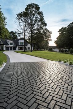 a brick walkway leading to a large house